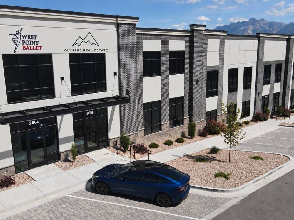 The Olympus Real Estate office with the Wasatch mountains behind it
